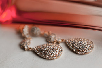 Silver earrings for the bride on a white table