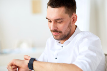 close up of businessman with smartwatch at office