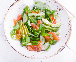Salmon salad with cucumber, arugula, spinach  and avocado