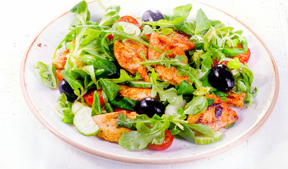 Healthy salad with chicken, arugula, cucumber  and tomato