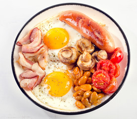 Full english breakfast. Fried egg, beans, tomatoes, mushrooms, bacon and sausage.