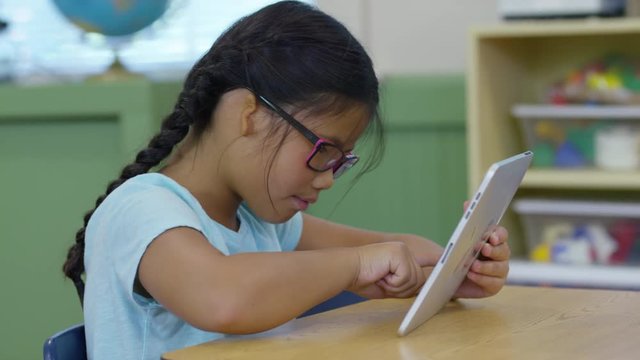 Student using digital tablet in school classroom
