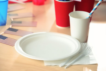 Fototapeta na wymiar Table setting with plastic ware for summer picnic