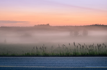 Landscape with mist and fog at summer night in Finland