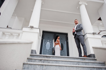 Young fashionable lovely couple at wedding anniversary and marriage proposal day against royal palace.