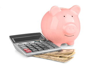 Fototapeta premium Piggy bank, banknotes and calculator on white background