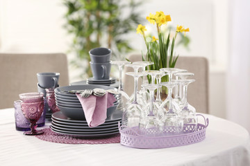 Obraz na płótnie Canvas Set of dishware with lilac accessories on table in restaurant