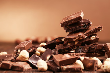 Pieces of dark and milk chocolate on blurred background