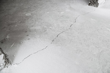 Crack in cement floor from shrinkage of house