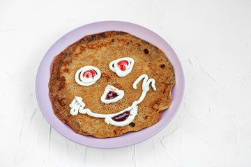 Chocolate pancake on a plate for kids. Breakfast. The concept of food and vegetarian.