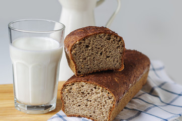 Homemade gluten free bread with linseed flour and psyllium husk. Glass of milk