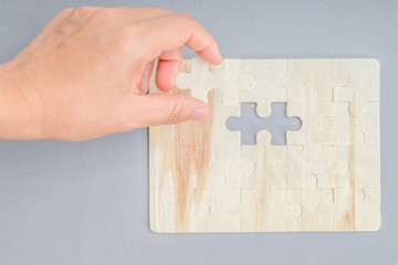 Person matching the last puzzle pieces.Concept image of building