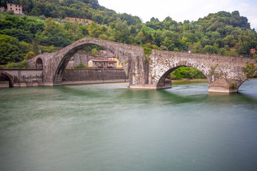 Fototapeta na wymiar Maddalena Bridge, ( Ponte della Maddalena), Borgo a Mozzano, Lucca, Italy, important medieval bridge in Italy. Tuscany.