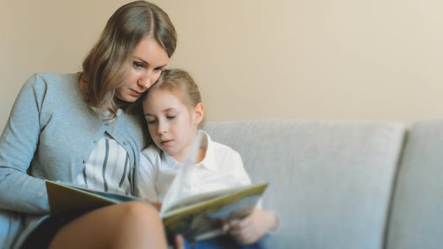 Mother and daughter reading a book.