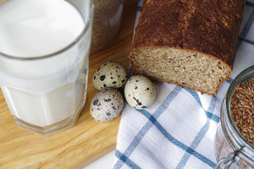 Homemade gluten free bread with linseed flour and psyllium husk. Glass of milk