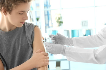 Doctor vaccinating patient in clinic