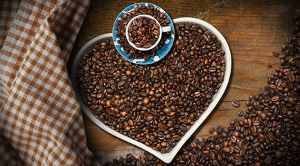 Roasted Coffee Beans in a Heart Shaped Bowl and a coffee cup
