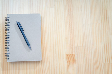 Notebook and pen on wooden desk