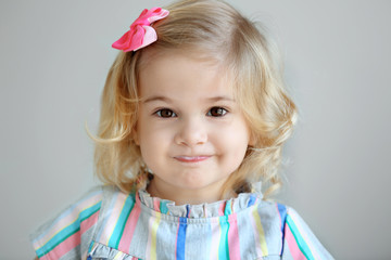 Cute little girl eating yogurt at home