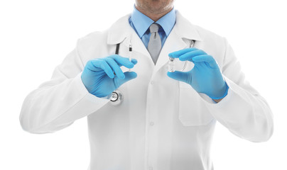 Doctor with syringe and medicine on white background, closeup