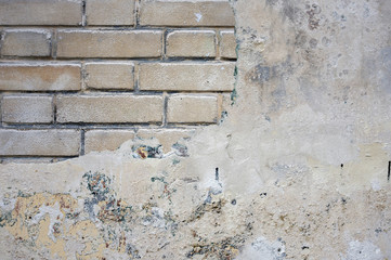 Gray concrete wall and detail of bricks, background or texture