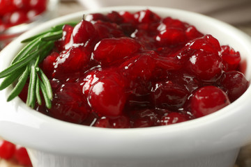 Delicious cranberry sauce in bowl, close up