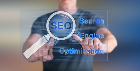 Man touching a seo concept on a touch screen