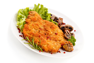 Fried pork chop with mushrooms on white background