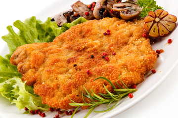 Fried pork chop with mushrooms on white background