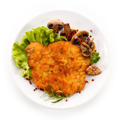 Fried pork chop with mushrooms on white background