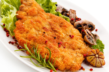 Fried pork chop with mushrooms on white background