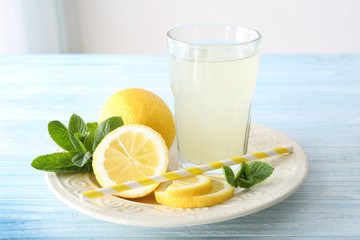 Delicious lemon juice in glass on kitchen table