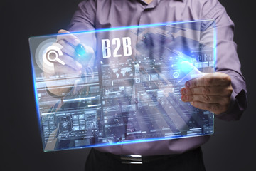 Business, Technology, Internet and network concept. Young businessman working on a virtual screen of the future and sees the inscription: B2B