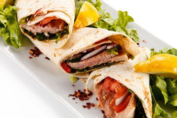 Spring rolls - wraps with meat and vegetables on white background