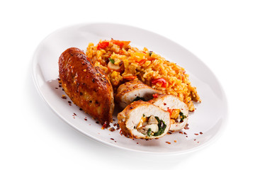 Stuffed chicken fillet with rice and vegetables on white background