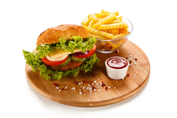 Big hamburger with french fries on white background