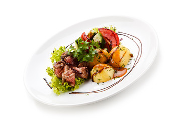 Carpaccio steaks with potatoes on white background