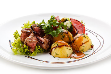 Carpaccio steaks with potatoes on white background