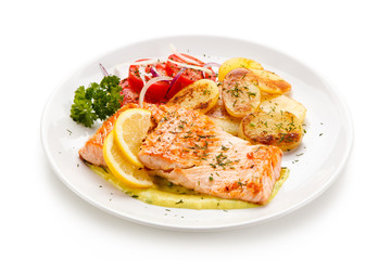 Grilled salmon with potatoes on white background