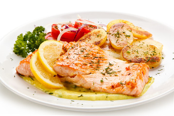 Grilled salmon with potatoes on white background