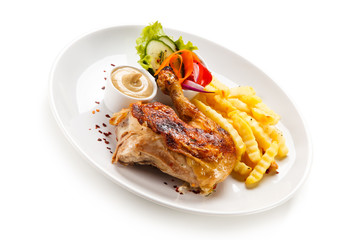 Roast chicken leg with french fries on white background