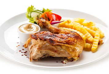 Roast chicken leg with french fries on white background