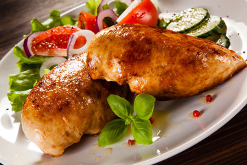 Grilled chicken fillet on wooden table