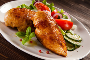 Grilled chicken fillet on wooden table
