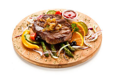 Grilled beefsteak with asparagus on cutting board