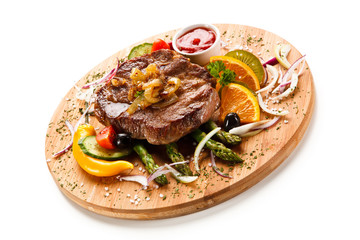 Grilled beefsteak with asparagus on cutting board