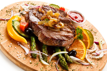 Grilled beefsteak with asparagus on cutting board