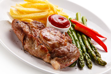 Grilled steak with french fries and asparagus on white background
