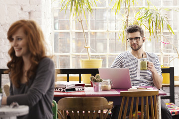 Hipster working and having breakfast