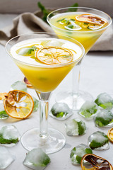 Citrus cocktail with ice, mint and orange slice.